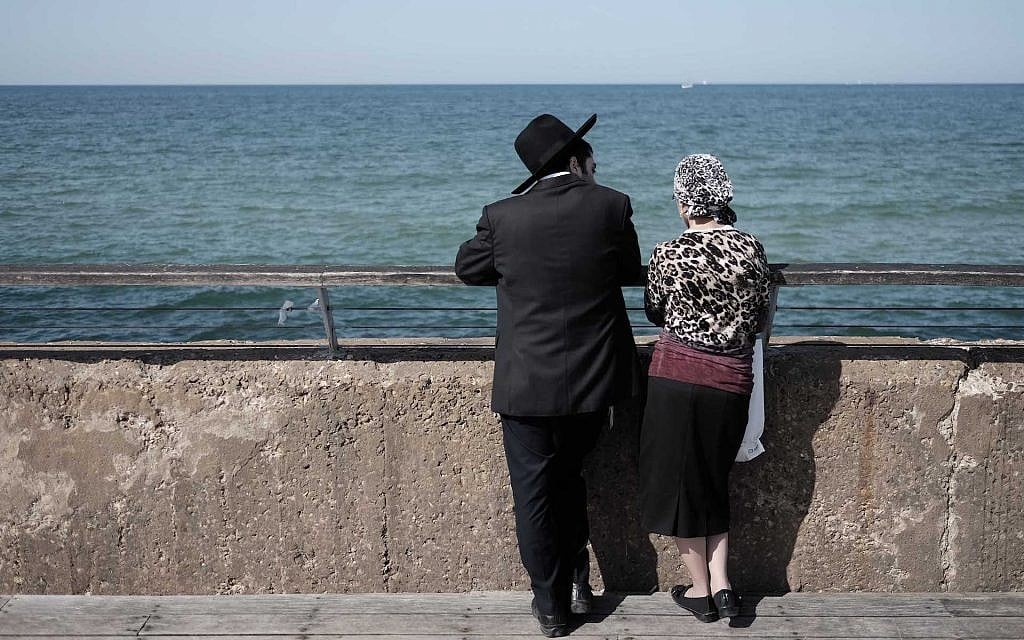 Illustrative: an ultra-Orthodox Jewish couple enjoys a sunny afternoon at the Tel Aviv port, February 5, 2016. (Tomer Neuberg/Flash90) Illustrative: an ultra-Orthodox Jewish couple enjoys a sunny afternoon at the Tel Aviv port, February 5, 2016. (Tomer Neuberg/Flash90)