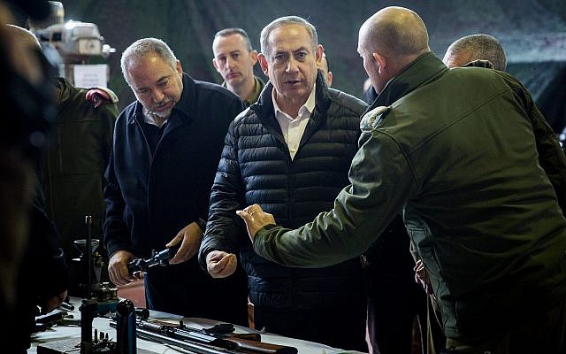 Illustrative: Prime Minister Benjamin Netanyahu (center) and Defense Minister Avigdor Liberman (right) view weapons in a Palestinian weapons factory discovered in the West Bank city of Hebron, during a visit to the IDF West Bank Division, near the Israeli settlement of Beit El. January 10, 2017. (Hadas Parush/FLASH90) Illustrative: Prime Minister Benjamin Netanyahu (center) and Defense Minister Avigdor Liberman (right) view weapons in a Palestinian weapons factory discovered in the West Bank city of Hebron, during a visit to the IDF West Bank Division, near the Israeli settlement of Beit El. January 10, 2017. (Hadas Parush/FLASH90)