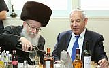 Prime Minister Benjamin Netanyahu is hosted by Minister of Health Yaakov Litzman of the United Torah Judaism party (left), at a meal to celebrate the birth of Litzman's grandson, June 18, 2017. (Shlomi Cohen/FLASH90)
