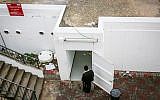A man walks near an open bomb shelter in the northern Israeli city of Safed on December 4, 2018. (David Cohen/Flash90)