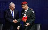 Prime Minister Benjamin Netanyahu (left) shakes hands with incoming IDF Chief of Staff Aviv Kohavi at IDF headquarters in Tel Aviv on January 15, 2019. (Flash90)
