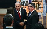 Prime Minister Benjamin Netanyahu shakes hands with Gideon Sa'ar during a Likud party meeting at the Menachem Begin Heritage Center in Jerusalem on March 11, 2019. (Yonatan Sindel/Flash90)