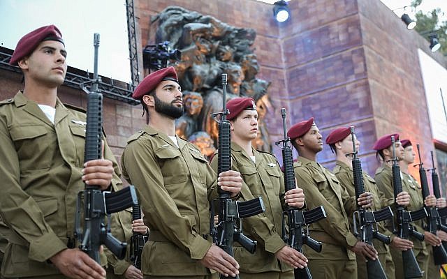 Israeli soldiers stand below a monument during a ceremony at Yad Vashem on Holocaust Remembrance Day on May 1, 2019. (Noam Rivkin Fenton/Flash90) Israeli soldiers stand below a monument during a ceremony at Yad Vashem on Holocaust Remembrance Day on May 1, 2019. (Noam Rivkin Fenton/Flash90)
