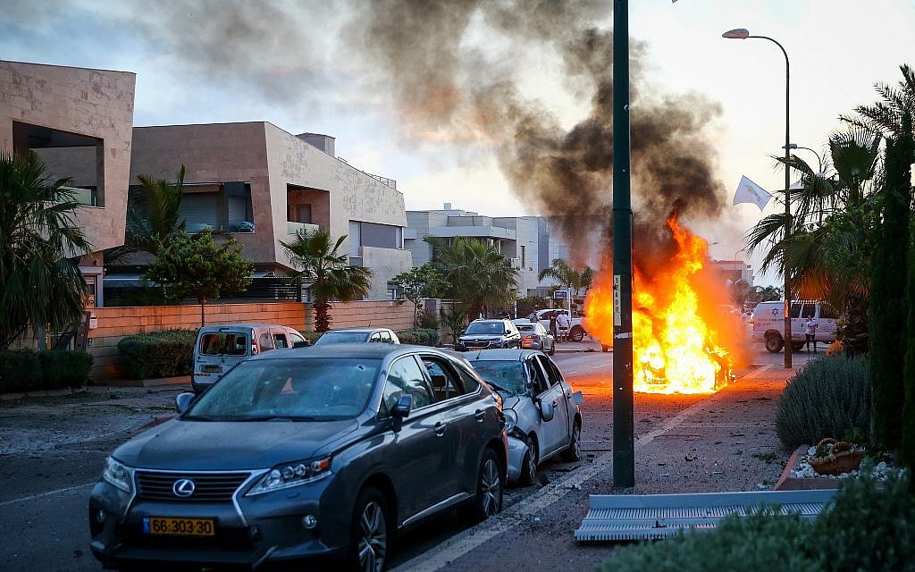 A car bursts into flames after it was hit by a rocket fired from the Gaza Strip in the southern Israeli city of Ashdod on May 5, 2019. (Flash90)