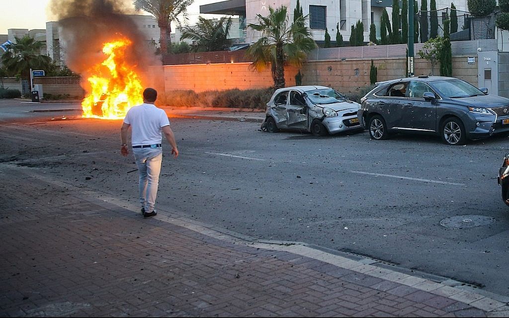 A car bursts into flames after it was hit by a rocket fired from the Gaza Strip in the southern Israeli city of Ashdod on May 5, 2019. (Flash90) A car bursts into flames after it was hit by a rocket fired from the Gaza Strip in the southern Israeli city of Ashdod on May 5, 2019. (Flash90)