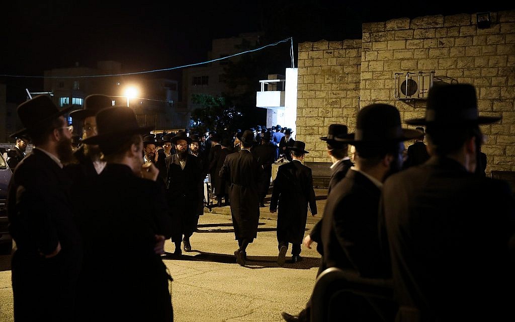 Ultra Orthoodx Jews stand outside the funeral of Pinchas Menahem Prezuazman in Jerusalem on May 5, 2019. Prezuazman was killed by shrapnel from a rocket fired from the Gaza Strip in Ashdod earlier Sunday . Hadas Parush/Flash90)