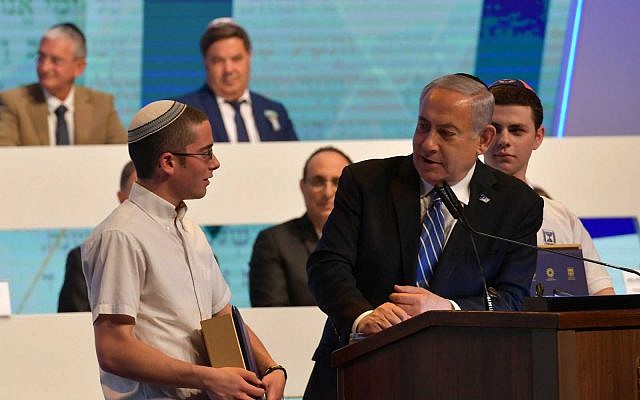 Prime Minister Benjamin Netanyahu, right, speaks to International Bible Quiz for Youth winner Yonatan Weisman of Jerusalem, left, on Israel's Independence Day, May 9, 2019. (Kobi Gideon/GPO) Prime Minister Benjamin Netanyahu, right, speaks to International Bible Quiz for Youth winner Yonatan Weisman of Jerusalem, left, on Israel's Independence Day, May 9, 2019. (Kobi Gideon/GPO)