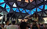 People dance in one of the many DJ spots at the Eurovision Village in Tel Aviv's Charles Clore Park on May 16, 2019. (Melanie Lidman/Times of Israel)