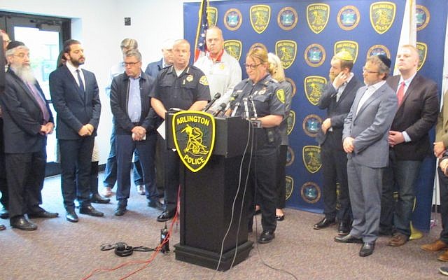 Julie Flaherty, acting police chief of Arlington, Mass., addresses a news conference at the town's police station as Rabbi Avi Bukiet, second from left, looks on, May 17, 2019. (Penny Schwartz) Julie Flaherty, acting police chief of Arlington, Mass., addresses a news conference at the town's police station as Rabbi Avi Bukiet, second from left, looks on, May 17, 2019. (Penny Schwartz)