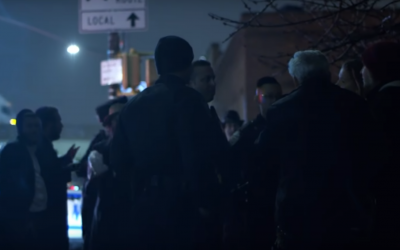 Police speak to model Marisa Papen and her photographer, as well as a group of ultra-Orthodox men, after she ran naked through their neighborhood, during the Purim holiday, on March 21, 2019. (Screen capture)