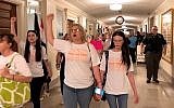Protesters march through the halls of the Missouri Capitol outside the House chamber on May 17, 2019, in Jefferson City, Missouri, in opposition to legislation prohibiting abortions at eight weeks of pregnancy. (AP Photo/David A. Lieb)