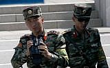 North Korean soldiers look at the South side at the border village of Panmunjom in the Demilitarized Zone, South Korea, May 1, 2019. (AP Photo/Lee Jin-man)