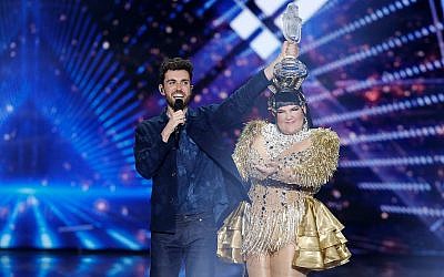 Duncan Laurence of the Netherlands celebrates winning the 2019 Eurovision Song Contest with the song "Arcade" in Tel Aviv, May 18, 2019. Behind him is 2018's winner, Israeli singer Netta Barzilai. (AP Photo/Sebastian Scheiner)