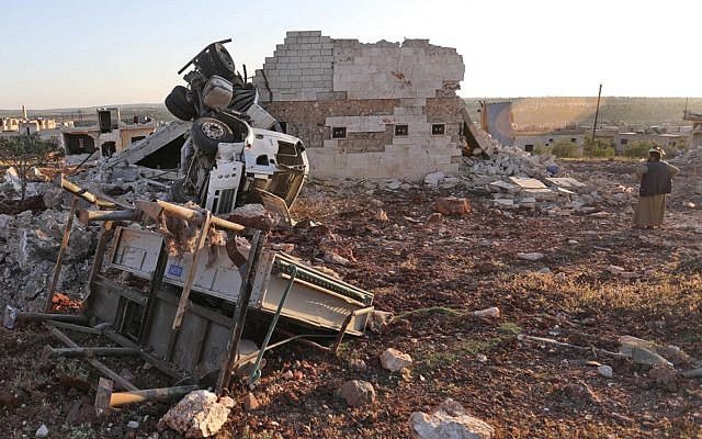 A man gazes at rubble and damaged vehicles following reported air strikes by the Syrian regime ally Russia, in the town of Kafranbel in the rebel-held part of the Syrian Idlib province on May 20, 2019. (OMAR HAJ KADOUR / AFP) A man gazes at rubble and damaged vehicles following reported air strikes by the Syrian regime ally Russia, in the town of Kafranbel in the rebel-held part of the Syrian Idlib province on May 20, 2019. (OMAR HAJ KADOUR / AFP)