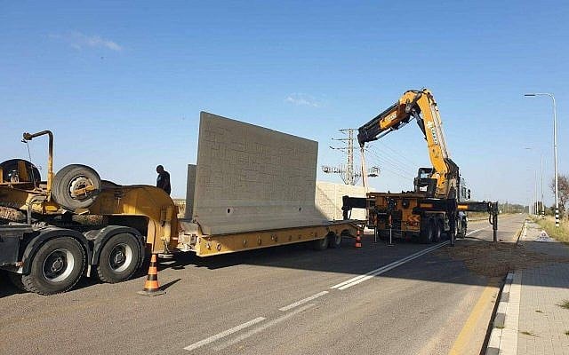 Workers put up a wall around a road near Kibbutz Erez in southern Israel to protect it against anti-tank guided missile on May 8, 2019. (Courtesy) Workers put up a wall around a road near Kibbutz Erez in southern Israel to protect it against anti-tank guided missile on May 8, 2019. (Courtesy)