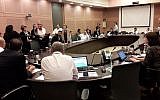 Ushers, at left, escort MK Mickey Levy (Blue and White) out of a Knesset committee debate on a bill to remove limits on the number of cabinet ministers that can be appointed by a government, May 21, 2019. (Knesset Spokesperson's Office)