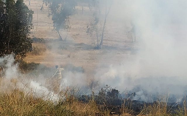 Firefighters work to extinguish a blaze in the Eshkol region of southern Israel that was sparked by a balloon-borne incendiary device from the Gaza Strip on May 22, 2019. (Eli Cohen/Fire and Rescue Services)