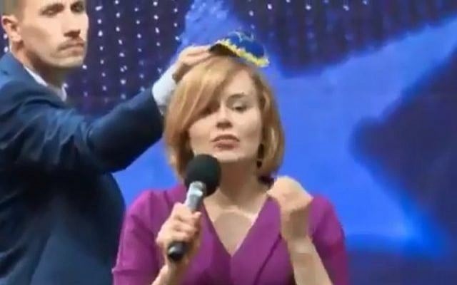 Polish politician Konrad Berkowicz puts a skullcap on the head of rival lawmaker Anna Krupka during a debate in Kielce on May 18, 2019. (screen capture: Twitter) Polish politician Konrad Berkowicz puts a skullcap on the head of rival lawmaker Anna Krupka during a debate in Kielce on May 18, 2019. (screen capture: Twitter)