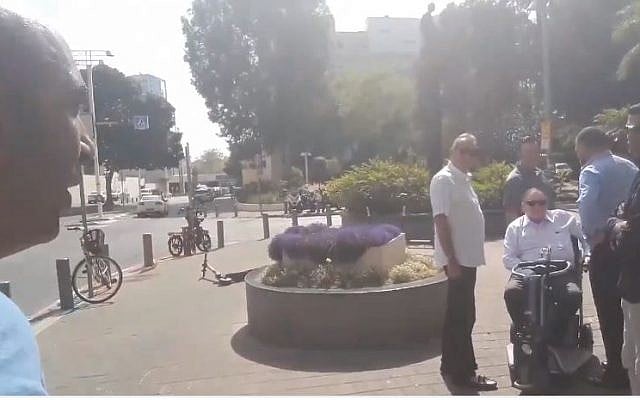 Activist Barak Cohen (L) films himself accosting Sheldon Adelson (seated) in Tel Aviv (Screencapture/Twitter) Activist Barak Cohen (L) films himself accosting Sheldon Adelson (seated) in Tel Aviv (Screencapture/Twitter)