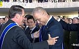 Brazilian President Jair Bolsonaro (L) awards the National Order of the Southern Cross, the country’s highest national honor for high-ranking guests, to Israel's ambassador in Brasilia Yossi Shelley on May 7, 2019 (Screencapture/YouTube)