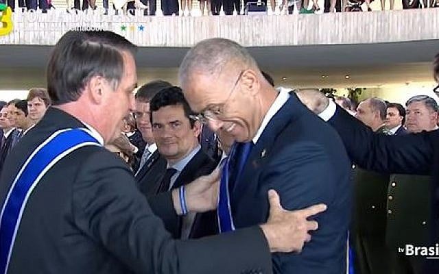 Brazilian President Jair Bolsonaro (L) awards the National Order of the Southern Cross, the country’s highest national honor for high-ranking guests, to Israel's ambassador in Brasilia Yossi Shelley on May 7, 2019 (Screencapture/YouTube) Brazilian President Jair Bolsonaro (L) awards the National Order of the Southern Cross, the country’s highest national honor for high-ranking guests, to Israel's ambassador in Brasilia Yossi Shelley on May 7, 2019 (Screencapture/YouTube)