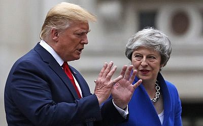 Britain's Prime Minister Theresa May, right, and US President Donald Trump, left, walk through the Quadrangle of the Foreign and Commonwealth Office (FCO) for a joint press conference in central London on June 4, 2019. (Frank Augstein/Various Sources/AFP)