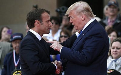 US President Donald Trump (R) talks with French President Emmanuel Macron during a ceremony commemorating the 75th anniversary D-Day at the Normandy American Cemetery and Memorial in Colleville-sur-Mer, Normandy, northwestern France, on June 6, 2019. (Ian Langsdon/Pool/AFP)