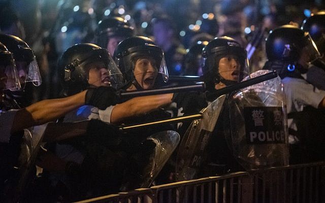 Riot police shout at protesters during clashes after a rally against a controversial extradition law proposal in Hong Kong on June 10, 2019 (Philip Fong/AFP)