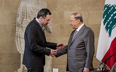 Lebanese President Michel Aoun (R) shakes hands with Nizar Zakka (C), a Lebanese national and US resident arrested in Iran in 2015 and sentenced to 10 years in jail on espionage charges, after he was freed, at the presidential palace in Baabda, east of the capital Beirut, on June 11, 2019.(Anwar Amro/AFP)