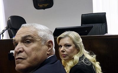 Sara Netanyahu, wife of Prime Minister Benjamin Netanyahu, and her lawyer Yossi Cohen (L) wait for the judge to arrive at the Jerusalem Magistrate's Court on June 16, 2019. (Photo by DEBBIE HILL / AFP)