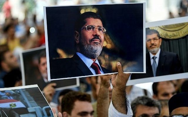 People hold a picture of the late Egyptian President Mohamed Morsi during a symbolic funeral ceremony on June 18, 2019 at Fatih mosque in Istanbul, Turkey. (AFP) People hold a picture of the late Egyptian President Mohamed Morsi during a symbolic funeral ceremony on June 18, 2019 at Fatih mosque in Istanbul, Turkey. (AFP)