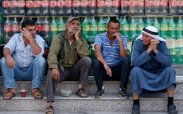 Palestinian men chat during a protest against a US-led meeting this week in Bahrain on the Palestinian-Israeli conflict, in the village of Yatta near the West Bank city of Hebron, on June 24, 2019. Finance officials were flying into Bahrain today for a US-led peace conference that holds out billions of dollars for the Palestinians, whose leaders pronounced the idea dead on arrival. The Palestinian Authority is boycotting the workshop, with prime minister Mohammad Shtayyeh criticising the plan for saying nothing about ending the Israeli occupation. (HAZEM BADER / AFP) Palestinian men chat during a protest against a US-led meeting this week in Bahrain on the Palestinian-Israeli conflict, in the village of Yatta near the West Bank city of Hebron, on June 24, 2019. Finance officials were flying into Bahrain today for a US-led peace conference that holds out billions of dollars for the Palestinians, whose leaders pronounced the idea dead on arrival. The Palestinian Authority is boycotting the workshop, with prime minister Mohammad Shtayyeh criticising the plan for saying nothing about ending the Israeli occupation. (HAZEM BADER / AFP)