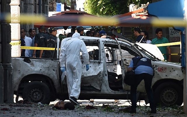 Tunisian forensic workers at the site of bombing attack in the capital's main avenue Habib Bourguiba on June 27, 2019. (FETHI BELAID / AFP) Tunisian forensic workers at the site of bombing attack in the capital's main avenue Habib Bourguiba on June 27, 2019. (FETHI BELAID / AFP)