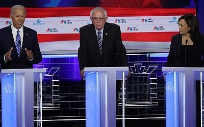 Sen. Kamala Harris (R) (D-CA) and former Vice President Joe Biden (L) speak as Sen. Bernie Sanders (I-VT) looks on during the second night of the first Democratic presidential debate in Miami, Florida on June 27, 2019. (Drew Angerer/Getty Images via JTA)