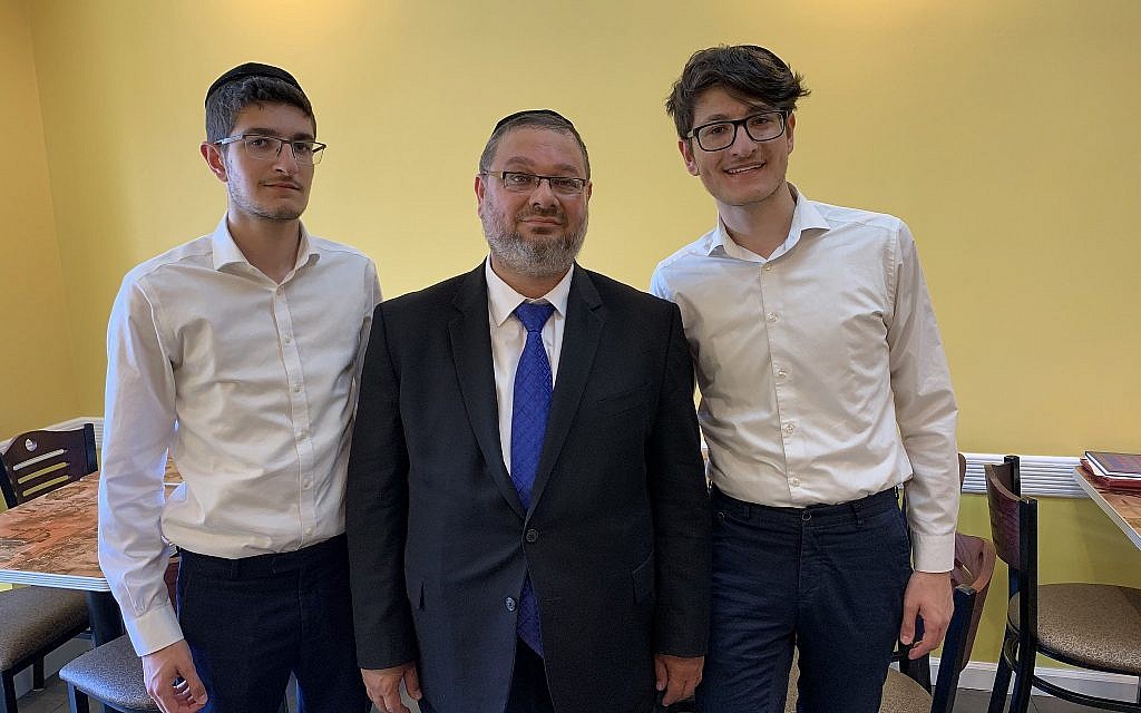 Owner of Sushi Kingdom & Asian Fusion in Kew Gardens Hills, Queens, Nahum Kaziev, center, with his sons Natan, left, and Yair. (Josefin Dolsten)