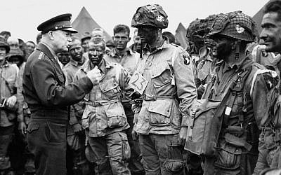 In this June 6, 1944, file photo, US Gen. Dwight D. Eisenhower, left, gives the order of the day to paratroopers in England prior to boarding their planes to participate in the first assault of the Normandy invasion. (US Army Signal Corps via AP)