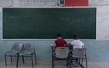 Two Palestinian students take a final exam on the last day of the school year, at the UNRWA Hebron Boys School in the West Bank city of Hebron, May 26, 2019. (AP/Nasser Nasser)