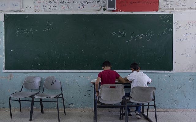 Two Palestinian students take a final exam on the last day of the school year, at the UNRWA Hebron Boys School in the West Bank city of Hebron, May 26, 2019. (AP/Nasser Nasser) Two Palestinian students take a final exam on the last day of the school year, at the UNRWA Hebron Boys School in the West Bank city of Hebron, May 26, 2019. (AP/Nasser Nasser)