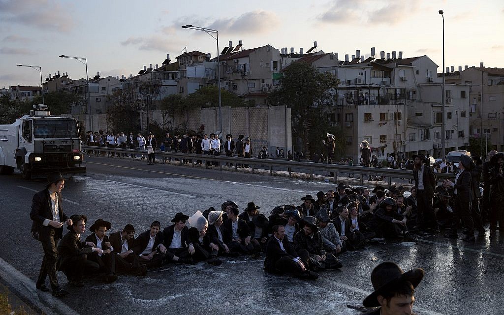 Ultra-Orthodox Jewish men block a highway during a protest against the detention of a member of their community who refused to serve in the military service, in Bnei Brak, Israel, March 12, 2018. (AP/Oded Balilty, File) Ultra-Orthodox Jewish men block a highway during a protest against the detention of a member of their community who refused to serve in the military service, in Bnei Brak, Israel, March 12, 2018. (AP/Oded Balilty, File)