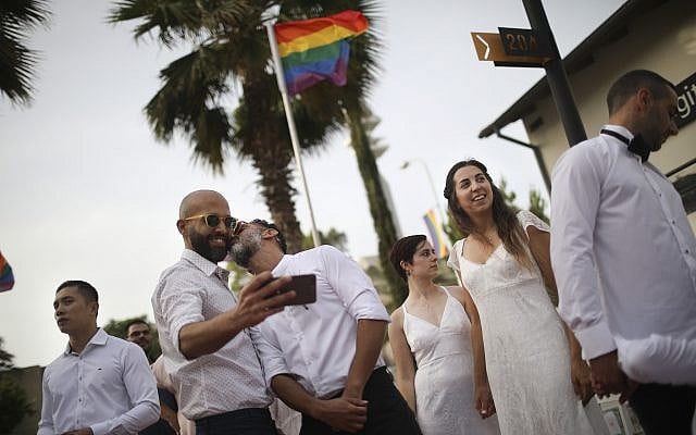 Gay couples prepare for a same-sex wedding in Tel Aviv, Israel, June 4, 2019. (AP/Oded Balilty)