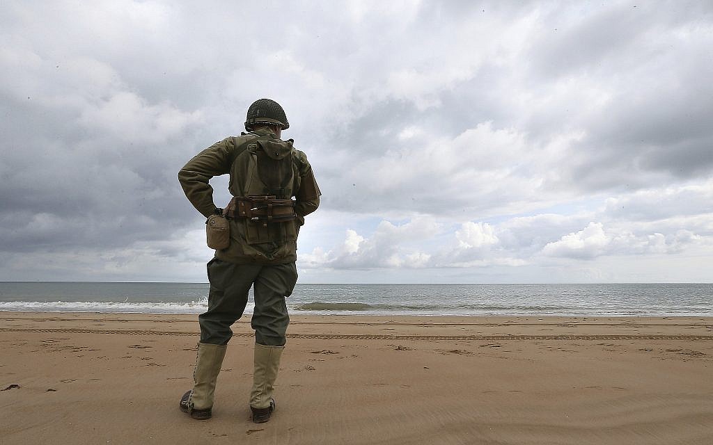 French enthusiast Julien watches the English Channel from Omaha Beach, Normandy, June 5, 2019, amid commemorations in the UK and France to honor the nearly 160,000 troops from Britain, the United States, Canada and other nations who landed in Normandy on June 6, 1944 in history's biggest amphibious invasion. (AP Photo/David Vincent)