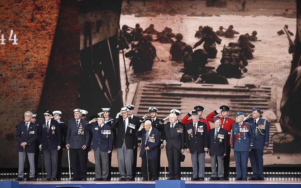 D-Day veterans, front row, stand on stage during an event to mark the 75th anniversary of D-Day in Portsmouth, England, June 5, 2019. World leaders including US President Donald Trump gathered on the south coast of England to mark the 75th anniversary of the D-Day landings. (AP Photo/Matt Dunham)