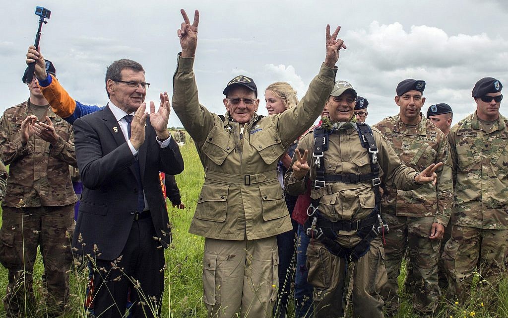 US World War II D-Day veteran Tom Rice, from Coronado, California, after parachuting in a tandem jump into a field in Carentan, Normandy, France, on June 5, 2019. Approximately 200 parachutists participated in the jump over Normandy, replicating a jump made by US soldiers on June 6, 1944 as a prelude to the seaborne invasions on D-Day. (AP Photo/Rafael Yaghobzadeh)