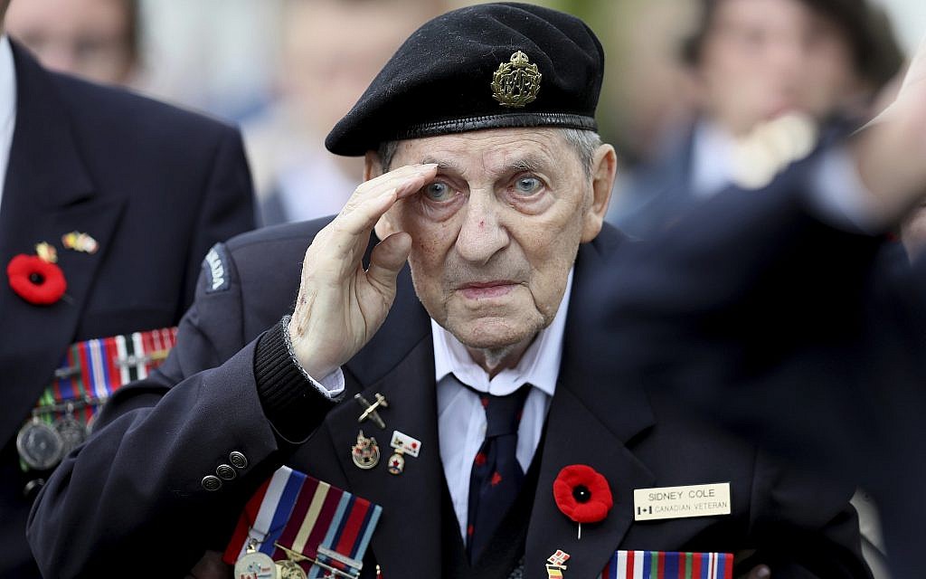 Canadian World War II veteran Sidney Cole salutes as he attends a ceremony at the Beny-sur-Mer Canadian War Cemetery in Reviers, Normandy, France, June 5, 2019. The ceremony was held for Canadians who fought and died on the beaches and in the bitter bridgehead battles of Normandy during World War II. (AP Photo/David Vincent)