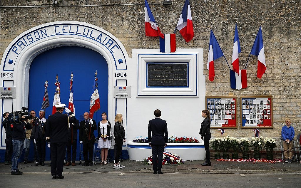 French president Emmanuel Macron attends a ceremony at the Caen prison to pay tribute to French resistants as part of D-Day ceremonies in Caen, June 5, 2019. On June 5, 1944, the Germans shot over 80 people at the prison of Caen, including 71 who have been identified as members of the French Resistance. (AP Photo/Francois Mori, pool)