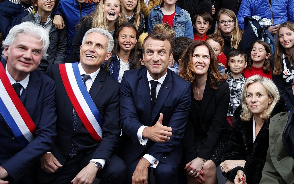 French President Emmanuel Macron poses for a group picture after a ceremony at the Caen prison to pay tribute to French resistants as part of D-Day ceremonies in Caen, June 5, 2019. On June 5, 1944, the Germans shot over 80 people at the prison, including 71 who have been identified as members of the French Resistance. (AP Photo/Francois Mori, pool)