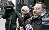 In this photo from February 1, 2007, Abdelhaleem Ashqar is surrounded by cameramen as he leaves federal court with his wife, in Chicago. (AP Photo/Charles Rex Arbogast)