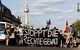 Picture taken June 18, 2019, shows people attending a protest rally in Berlin, Germany, against far right violence. Slogan reads 'Stop Far Right Violence' (Christoph Soeder/dpa via AP)