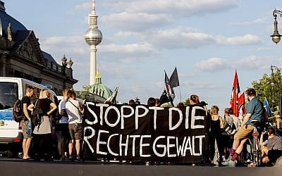 Picture taken June 18, 2019, shows people attending a protest rally in Berlin, Germany, against far right violence. Slogan reads 'Stop Far Right Violence' (Christoph Soeder/dpa via AP)