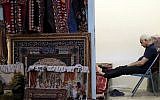 A carpet seller sits at his shop in the old main bazaar in Tehran, Iran, on June 23, 2019. (AP Photo/Ebrahim Noroozi)